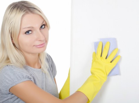 Carpet cleaner using protective equipment during a job